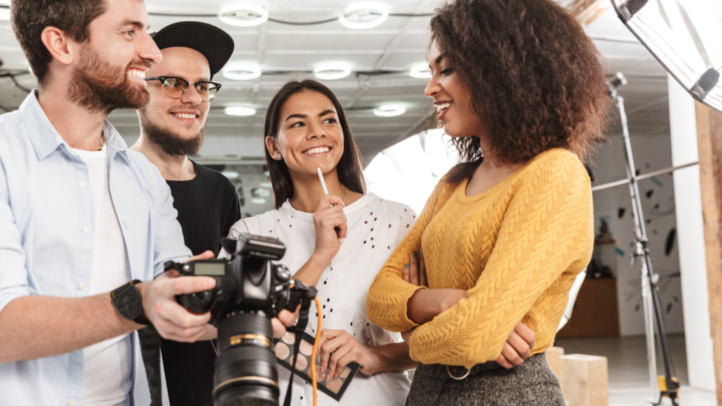 A host and a photographer reviewing photos on a camera during a shoot collaboration.