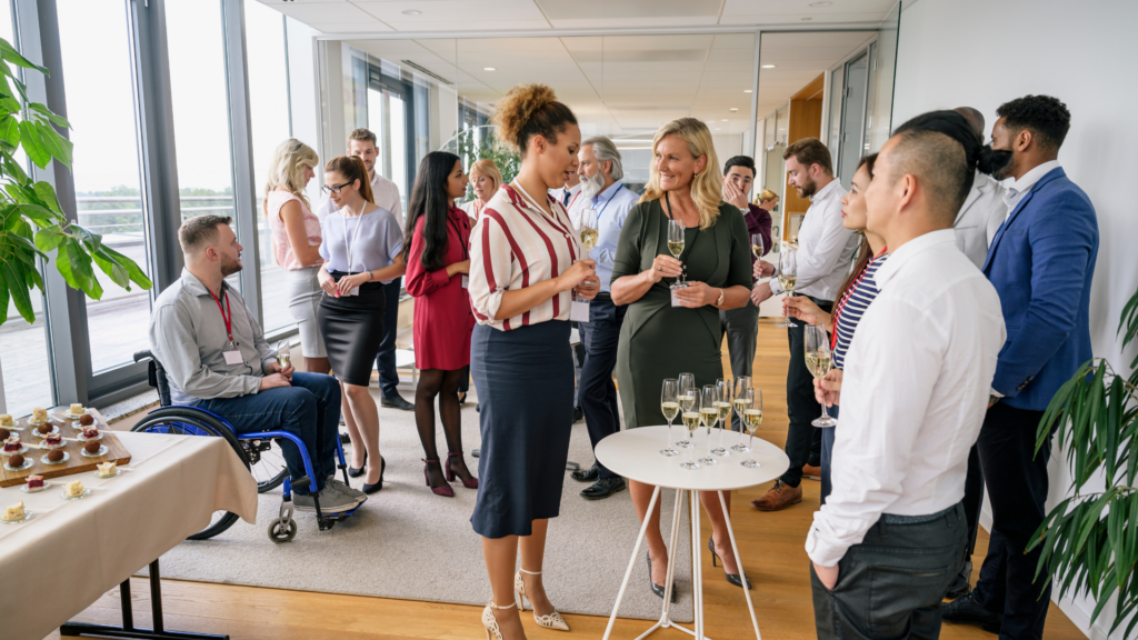 Industry professionals shaking hands and exchanging business cards at a networking event.