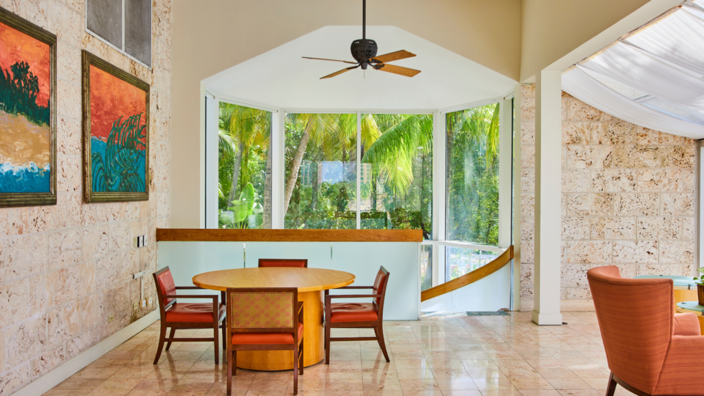 A mid-century modern living room with sleek furniture and large windows.