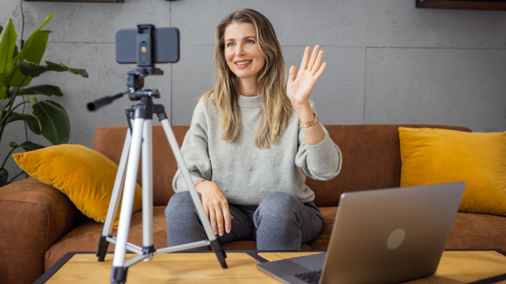Woman recording video to manage social media and multi-channel marketing campaigns.