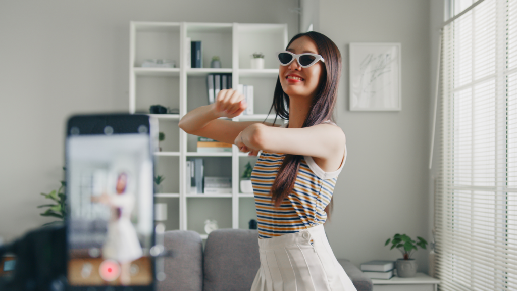 a behind-the-scene photo of a girl doing tiktoks. 